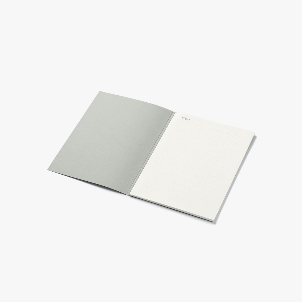 The NOMOS pad in A4 format is protected by a light gray cover. 50 sheets, dotted on both sides, tear off at the top.